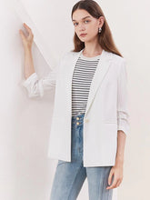 a woman in white blazer